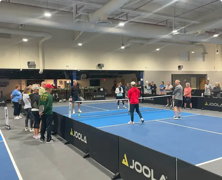 a group of people on a pickleball court