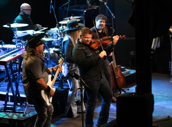 a group of people playing instruments on a stage