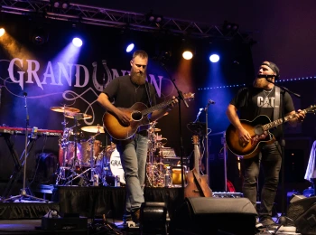 a group of men playing instruments on a stage