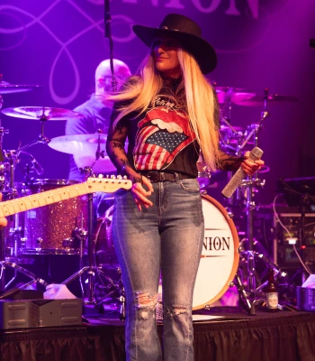 a woman singing on a stage