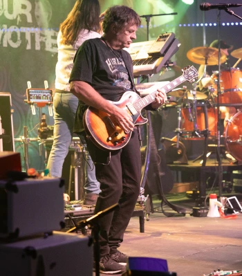 a man playing a guitar on a stage